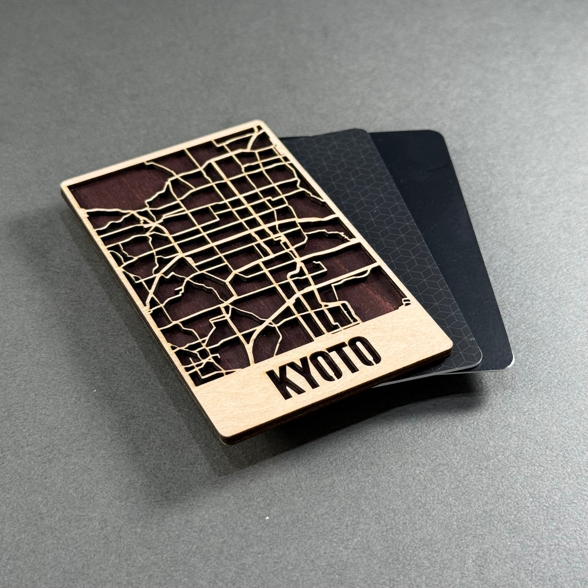Wooden mini map of Kyoto shown beside credit cards for size comparison
