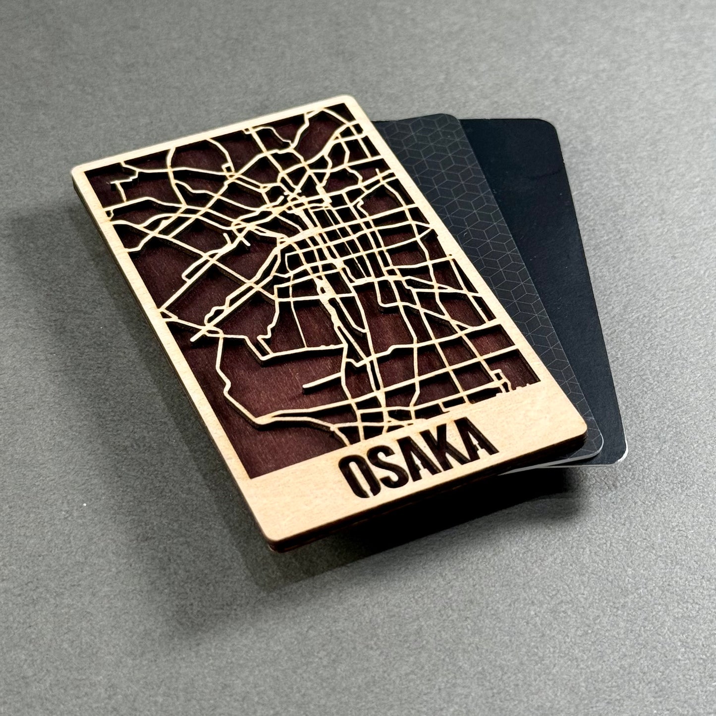Wooden mini map of Osaka shown beside credit cards for size comparison